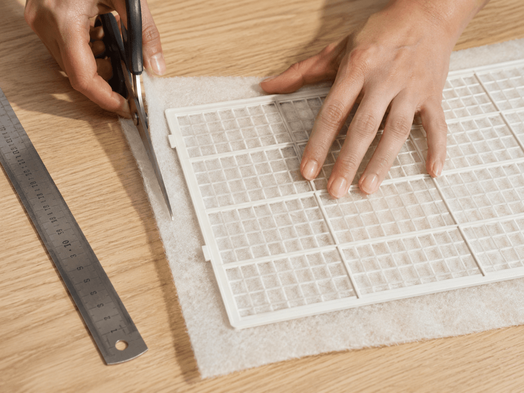 Cutting aftermarket filter media to fit a window AC filter slot